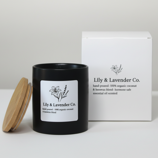 Lily & Lavender Co. Non-Toxic Coconut Wax & Beeswax Candle being lit with a match, next to box package.