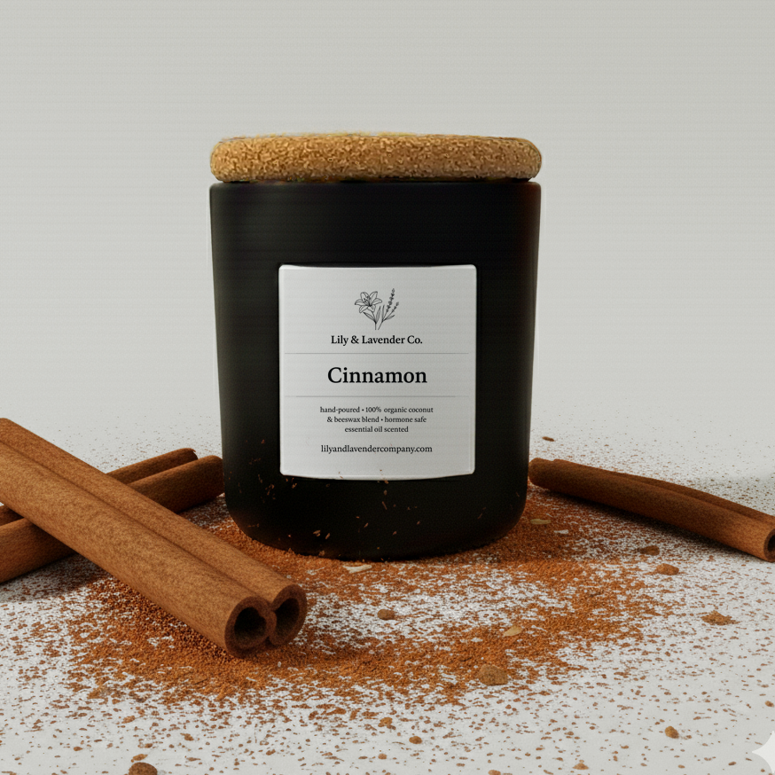 Lily & Lavender Co. Cinnamon, Essential Oil Scented, Non-Toxic Coconut & Beeswax Candle sitting with cinnamon sticks & cinnamon.