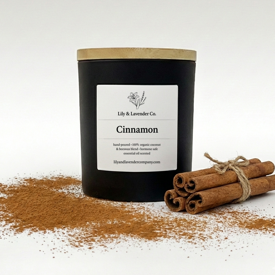 Lily & Lavender Co. Cinnamon, Essential Oil Scented, Non-Toxic Coconut & Beeswax Candle sitting with cinnamon sticks & cinnamon.