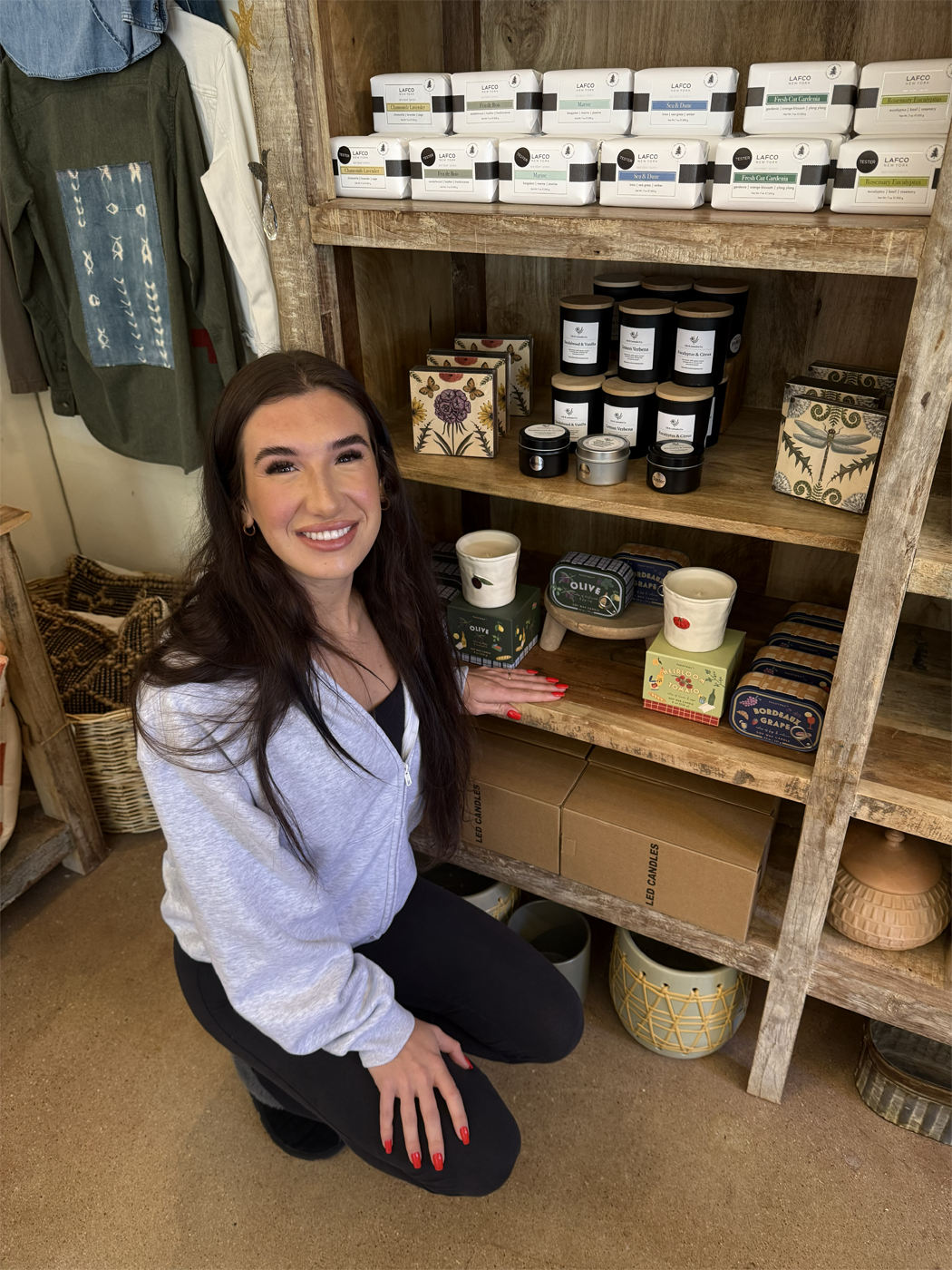 Lily & Lavender Co. Owner, Jacey Vickrey next to her Non-toxic, all natural candles at one of the many retailers who sell her candles. 
