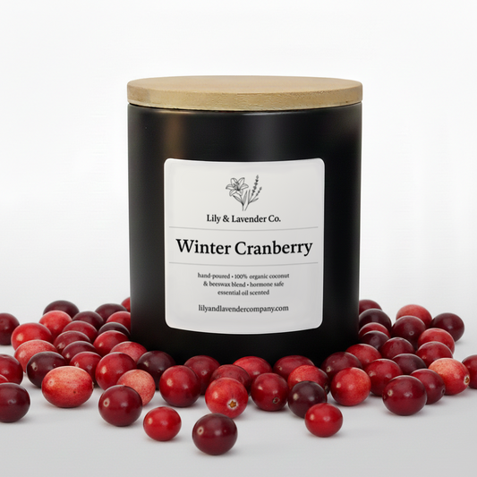 Lily & Lavender Co. Winter Cranberry, Essential Oil Scented, Non-Toxic Coconut & Beeswax Candle surrounded by cranberries.